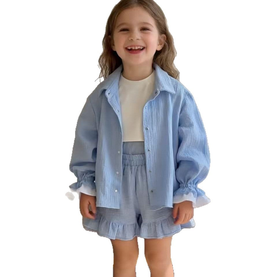 Two piece set of solid color shirt with ruffled shorts